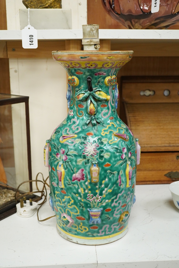 A late 19th century Chinese enamelled porcelain green ground vase with relief decoration, mounted as a lamp, 48cm high overall